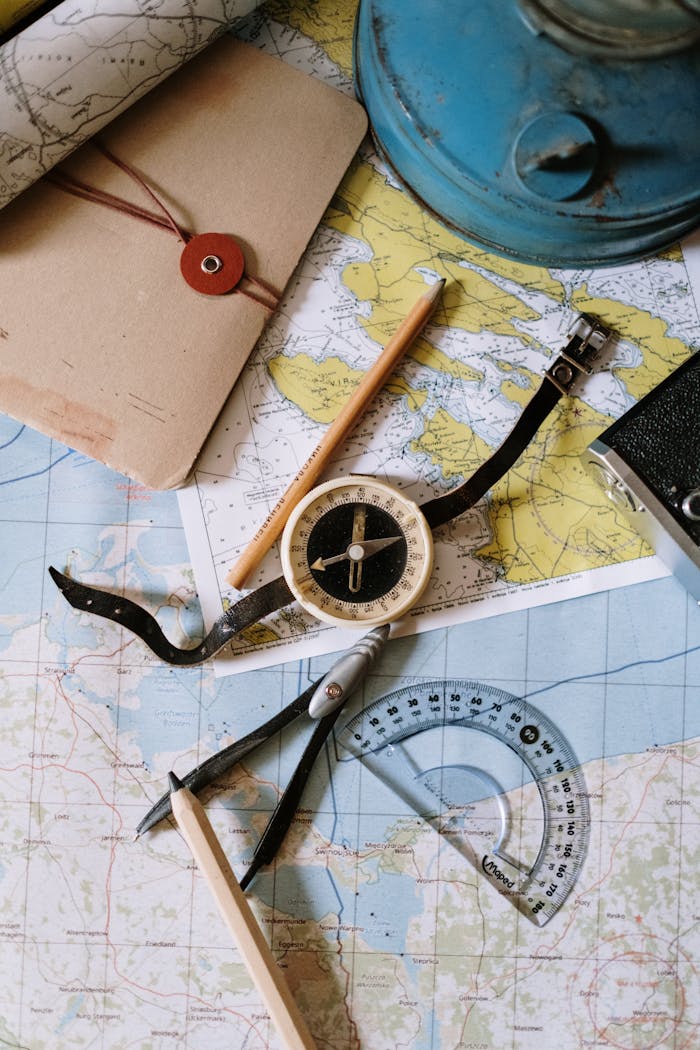 Crafting Captivating Headlines: Your awesome post title goes here Flat lay of vintage compass, protractor, and maps for navigation study.